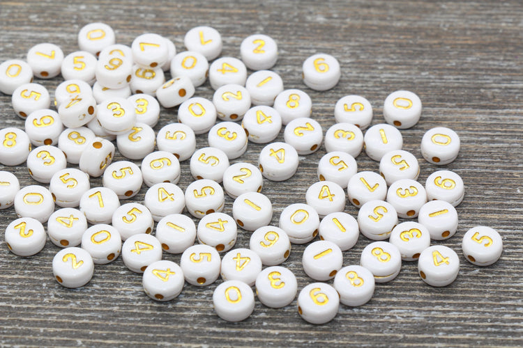 White beads with gold numbers printed on each, perfect for number bracelet, jewelry and craft projects