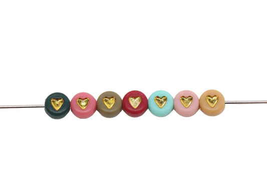 colorful beads with gold heart on a white background
