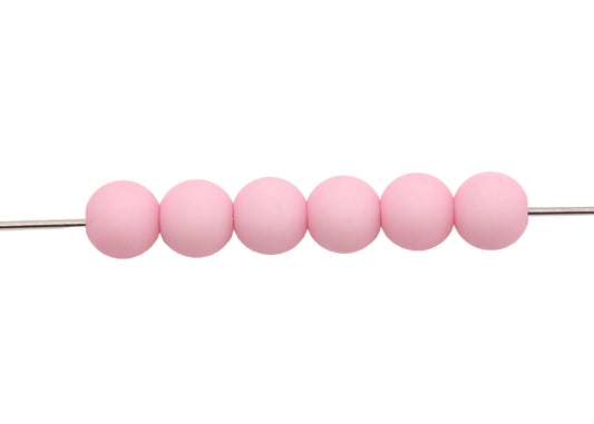 Row of pink beads on a white background