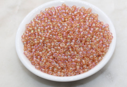 Transparent peach AB 4mm 6/0 round glass seed beads with iridescent finish for bracelets, jewelry making, beadwork, and DIY crafts