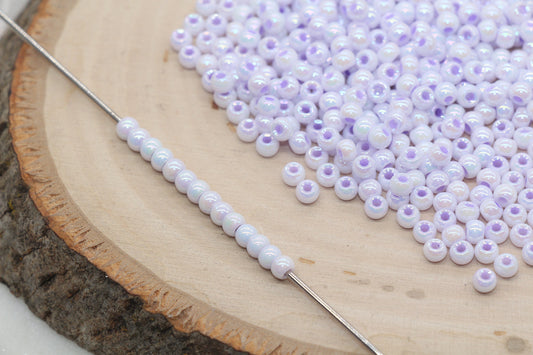 Lilac purple AB 4mm round glass seed beads with shiny iridescent finish for bracelets, jewelry making, and DIY craft projects