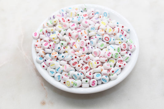 white 7 mm round acrylic number beads with multicolor numbers; white beads with multicolor numbers