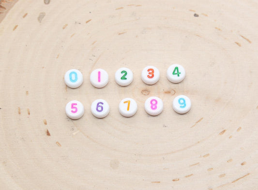 individual 7 mm round acrylic number beads, multicolor on white; multicolor number beads