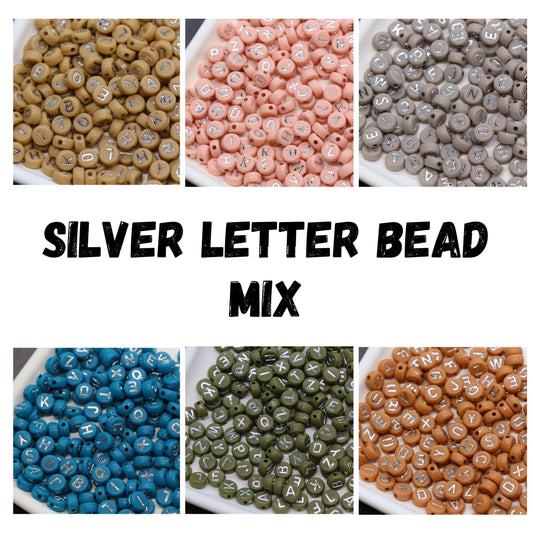 Mixed silver letter beads in assorted colors including beige, pink, gray, blue, green, and terracotta — round alphabet beads for jewelry making.