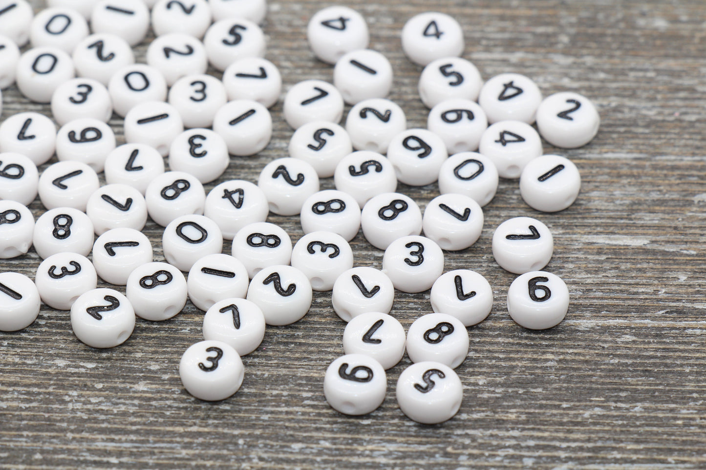 individual 7 mm flat round acrylic number beads, white with black numbers; white number beads