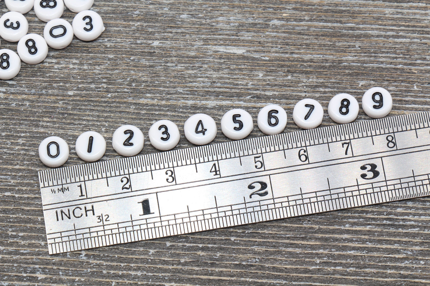 individual 7 mm flat round acrylic number beads, white with black numbers; white number beads
