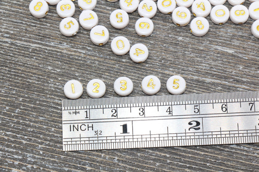 7 mm round acrylic number beads, white with gold numbers; 7mm round