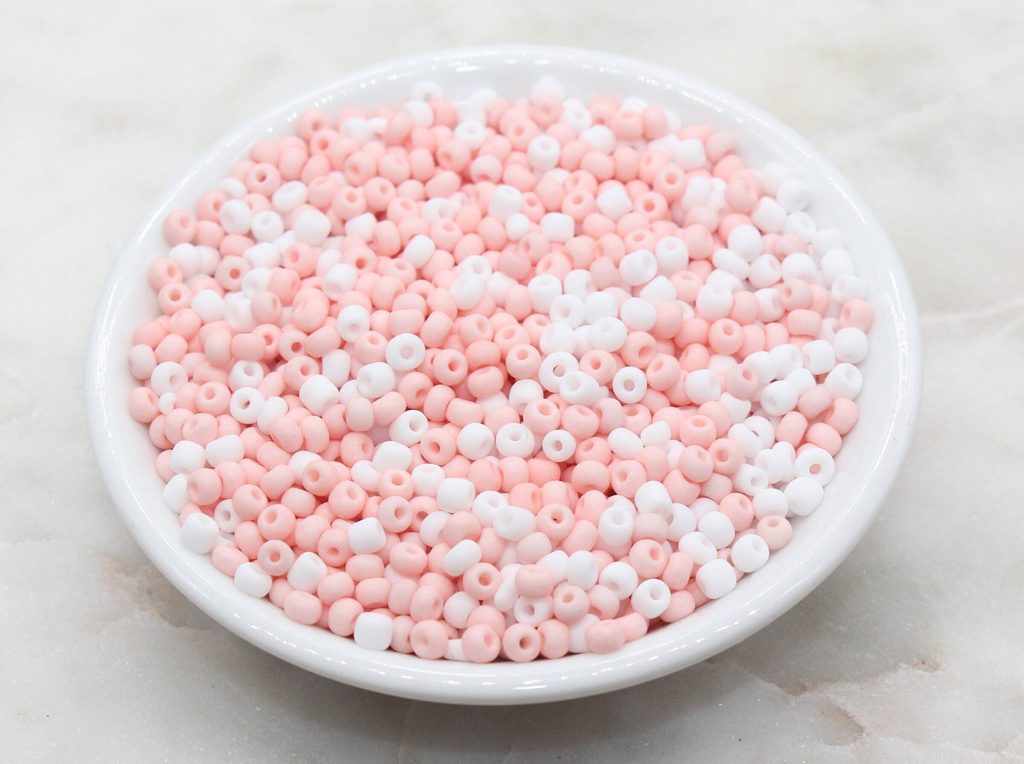 Assorted vibrant seed beads in various colors and sizes, ideal for crafting jewelry such as bracelets and necklaces and other craft