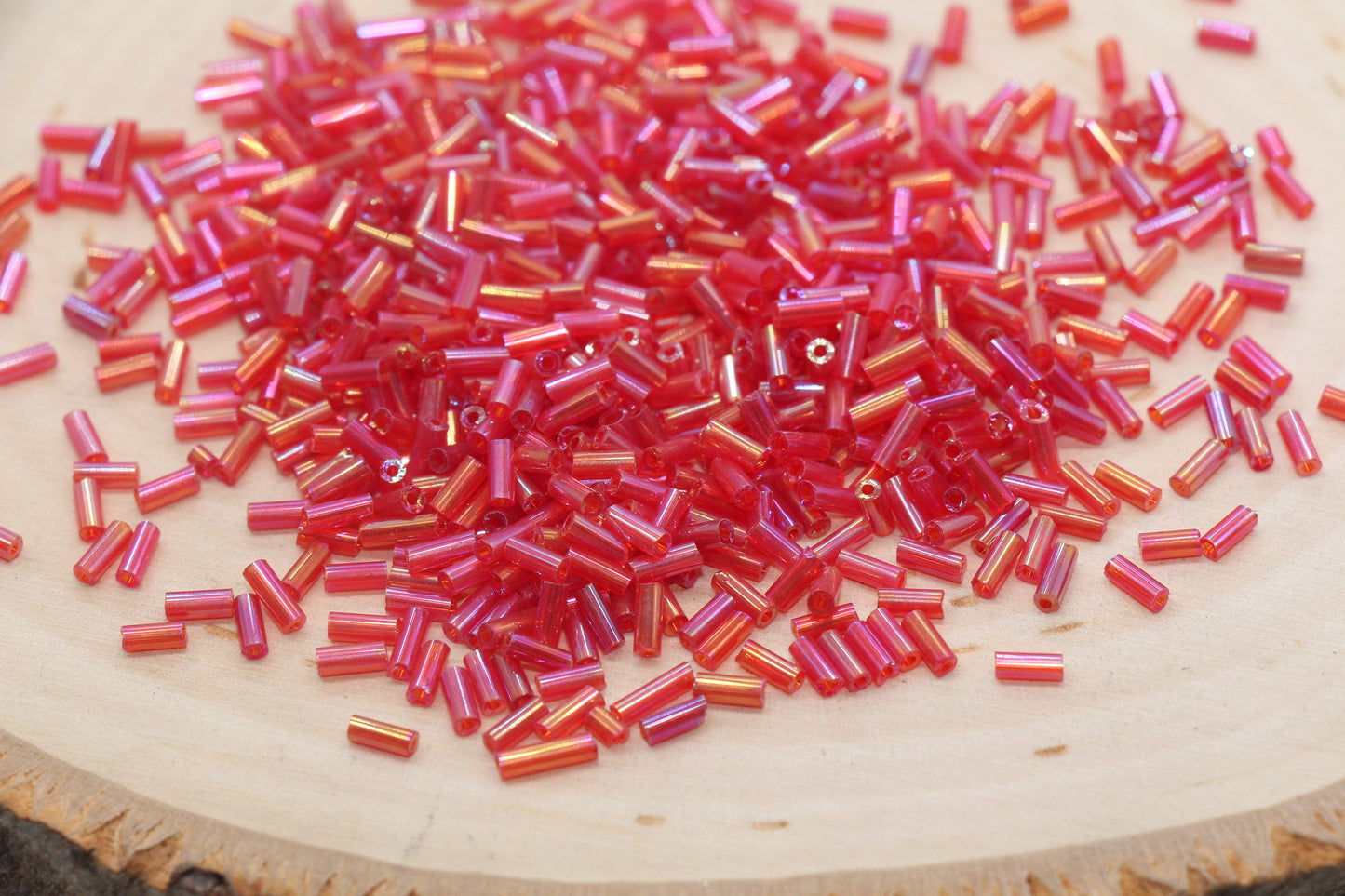 Red AB Bugle Beads, perfect for embellishing clothing, accessories, and craft projects.