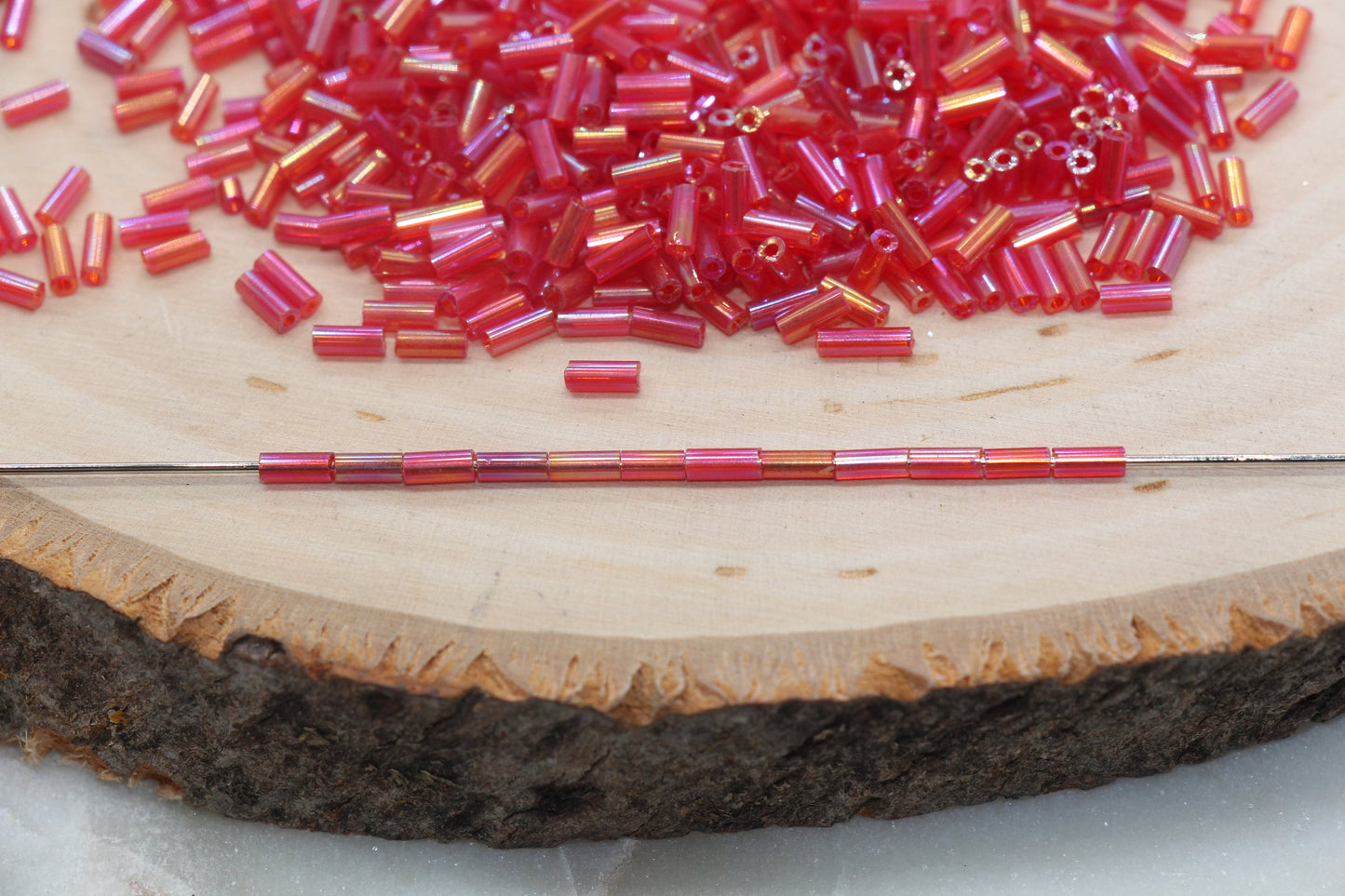 Red AB Bugle Beads, perfect for embellishing clothing, accessories, and craft projects.