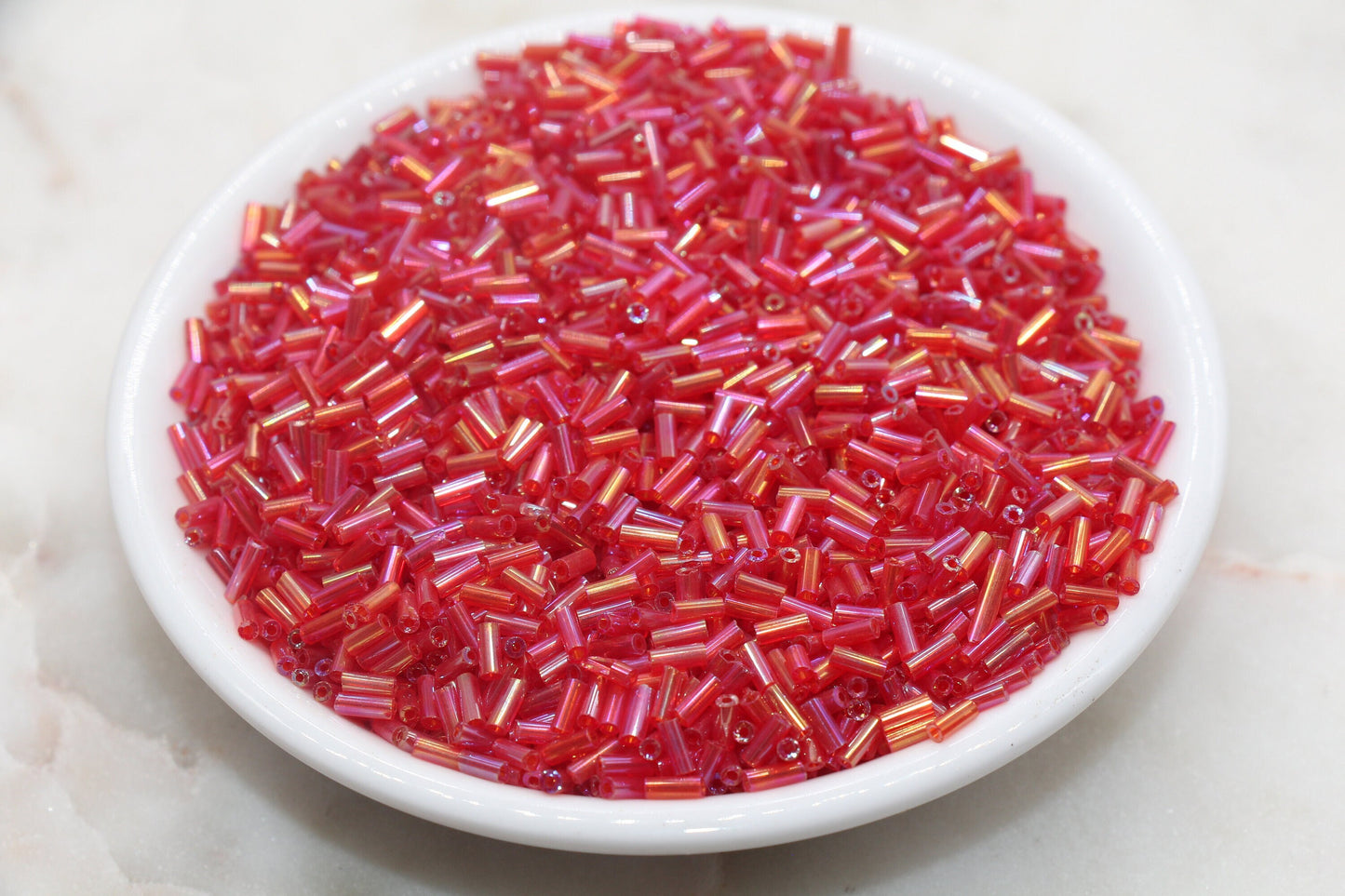 Red AB Bugle Beads, perfect for embellishing clothing, accessories, and craft projects.
