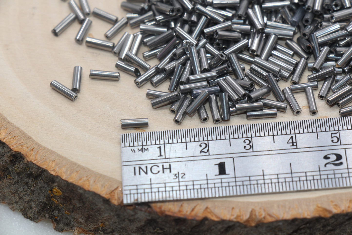 6mm Gunmetal Bugle Beads, perfect for embellishing clothing, accessories, and craft projects.