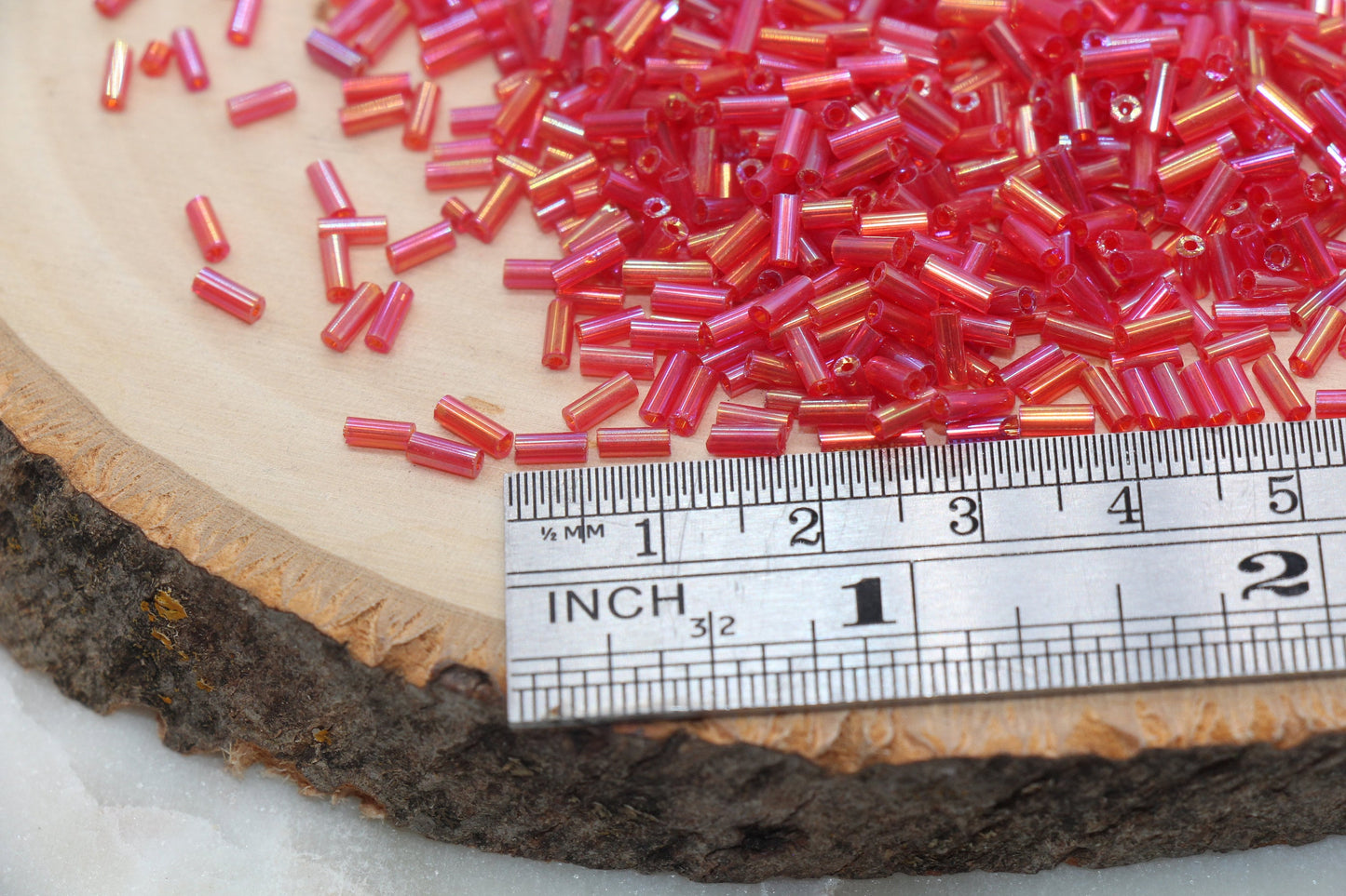 Red AB Bugle Beads, perfect for embellishing clothing, accessories, and craft projects.