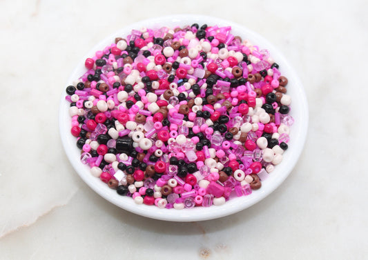 Assorted vibrant seed beads in various colors and sizes, ideal for crafting jewelry such as bracelets and necklaces and other craft