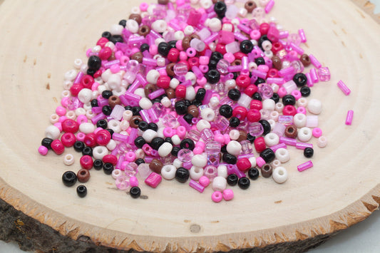 Assorted vibrant seed beads in various colors and sizes, ideal for crafting jewelry such as bracelets and necklaces and other craft
