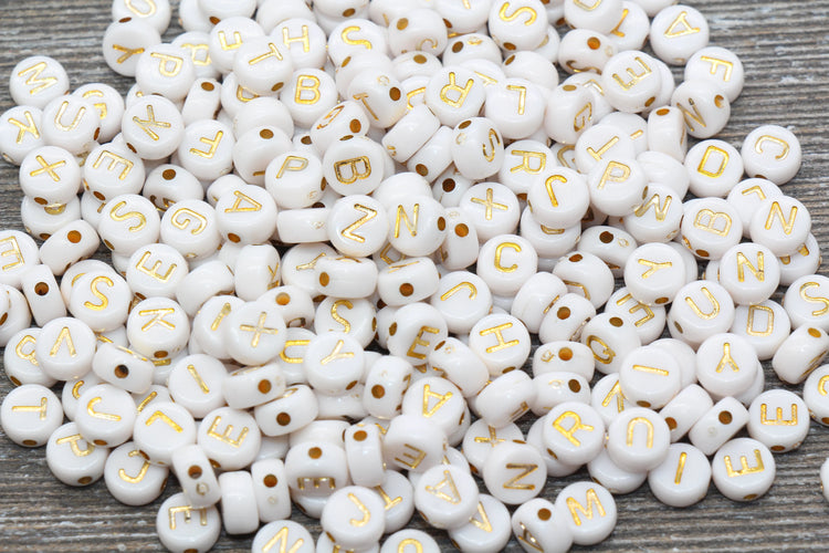 White beads with gold letters printed on them