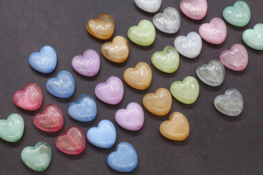 A collection of multicolored heart-shaped glitter beads