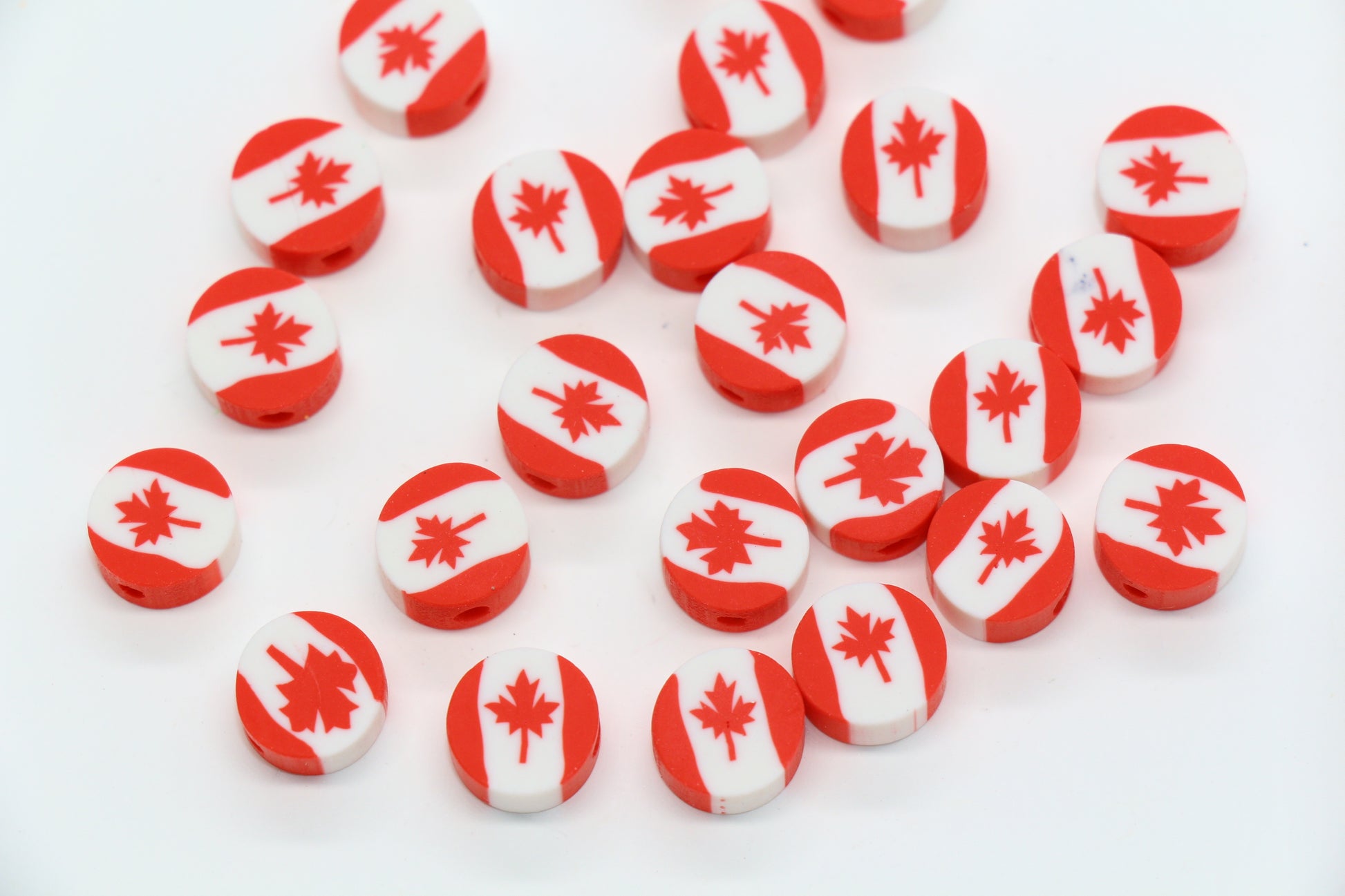 Red and white beads with Canadian flag design on a white background
