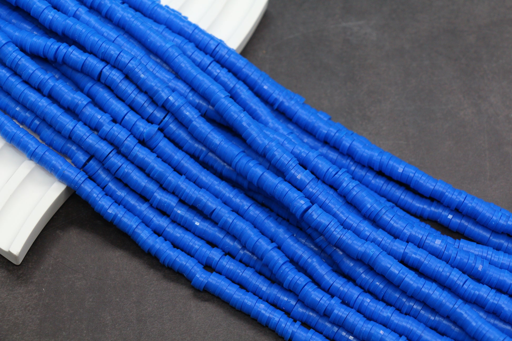 Blue cylindrical beads on a dark surface