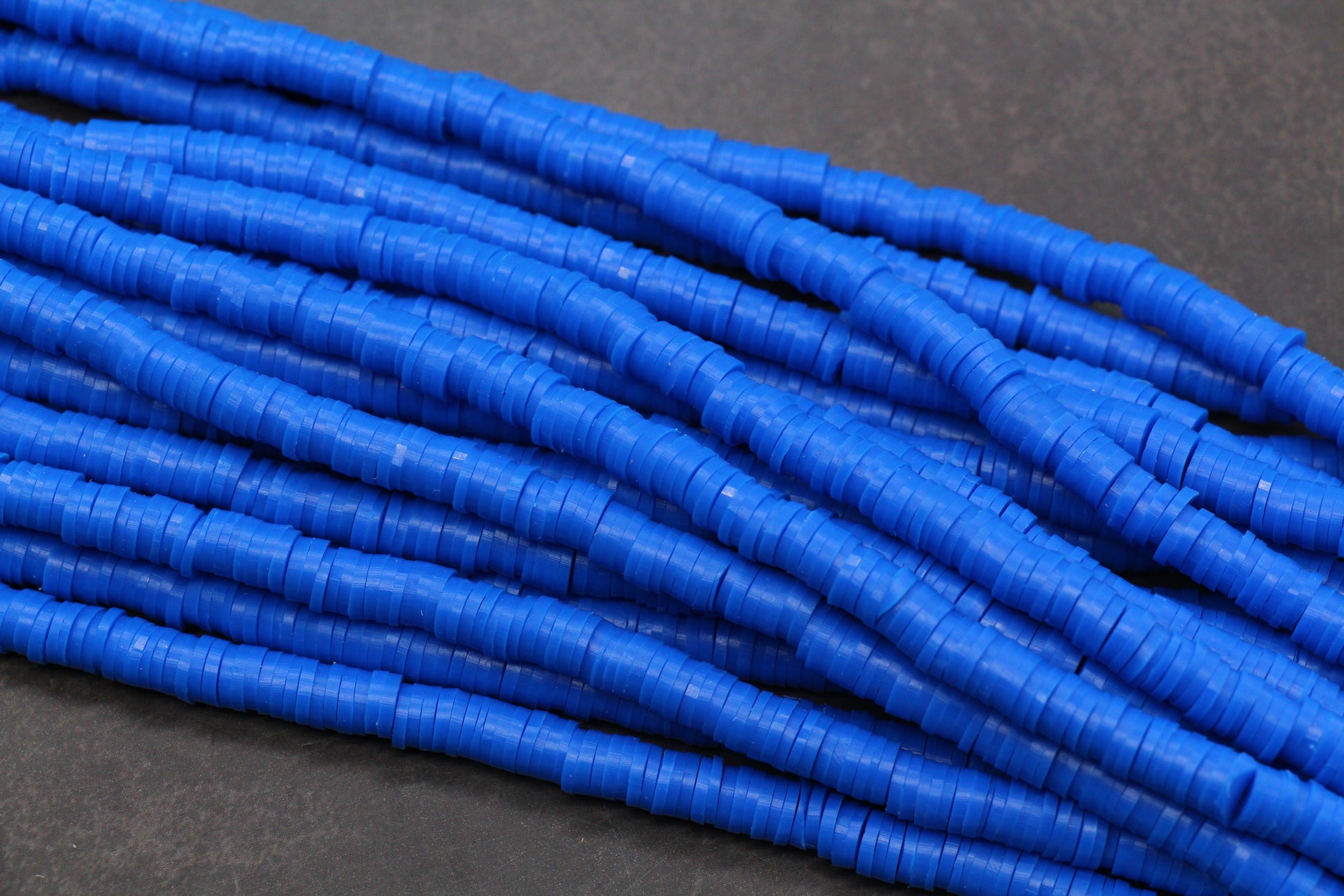 Close-up of blue cylindrical beads on a gray background