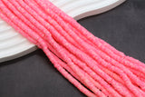 Close-up of pink beads on a dark surface