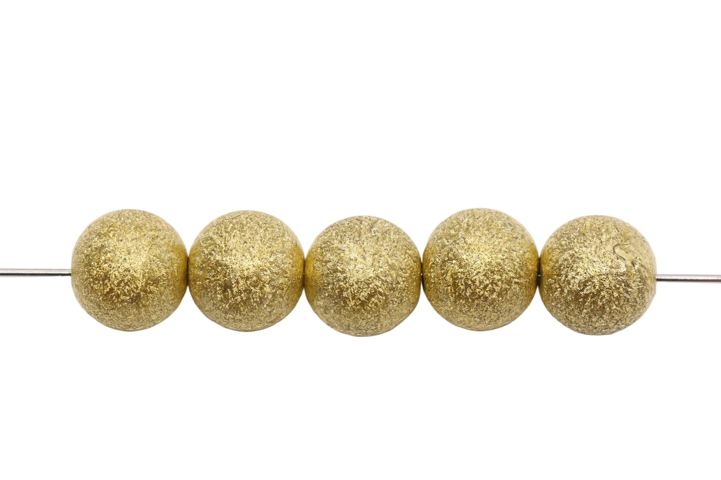 Five gold beads on a white background