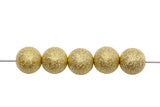 Five gold beads on a white background