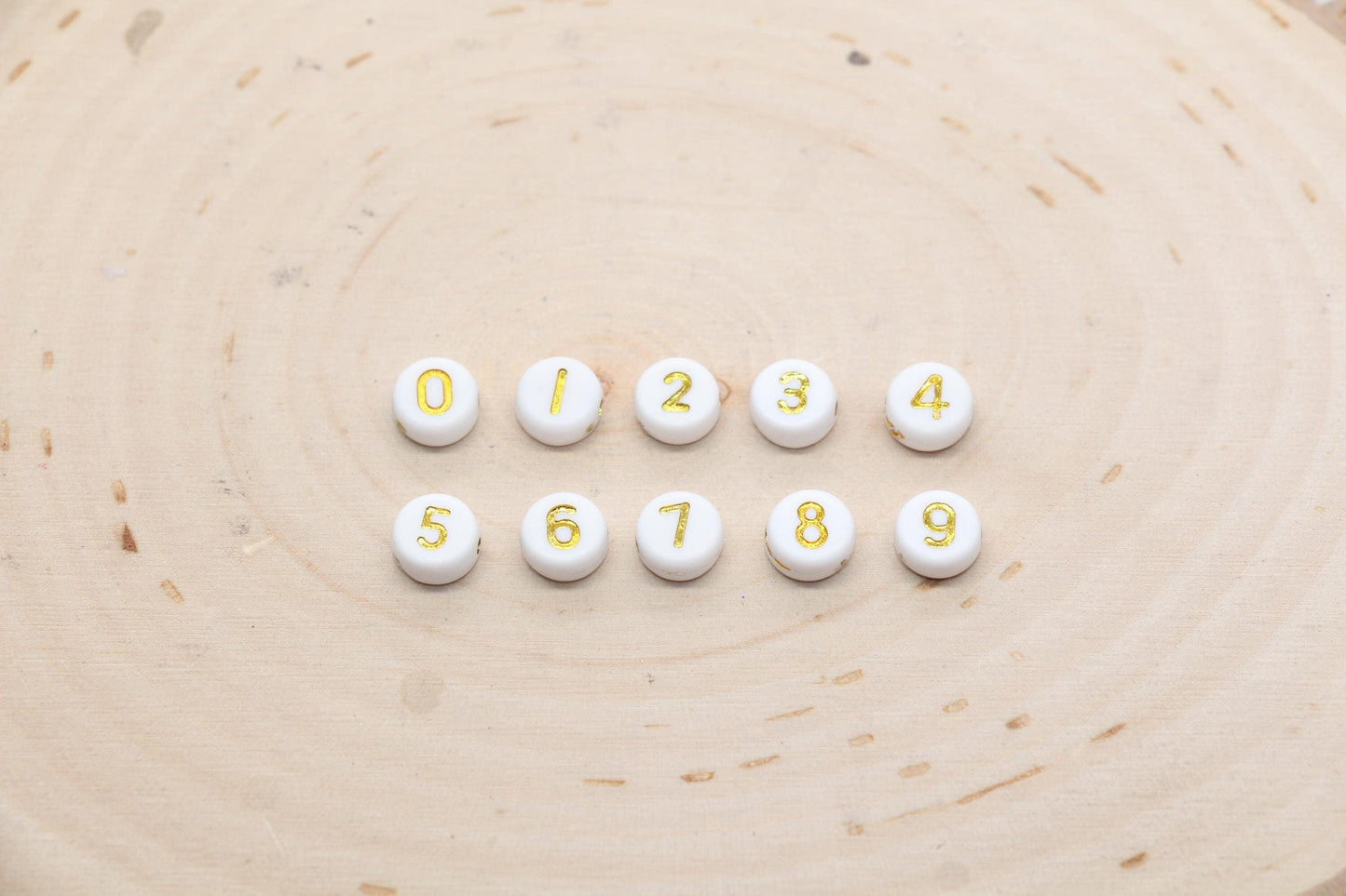individual 7 mm round acrylic number beads, gold on white; gold number beads