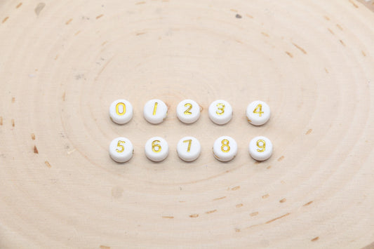 individual 7 mm round acrylic number beads, gold on white; gold number beads