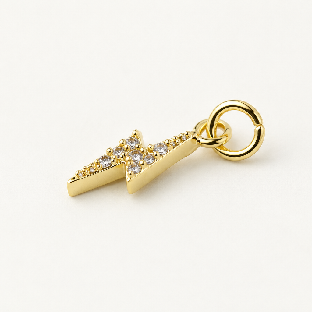 Angled gold-plated CZ lightning bolt charm with attached jump ring