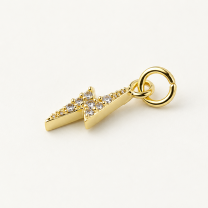 Angled gold-plated CZ lightning bolt charm with attached jump ring
