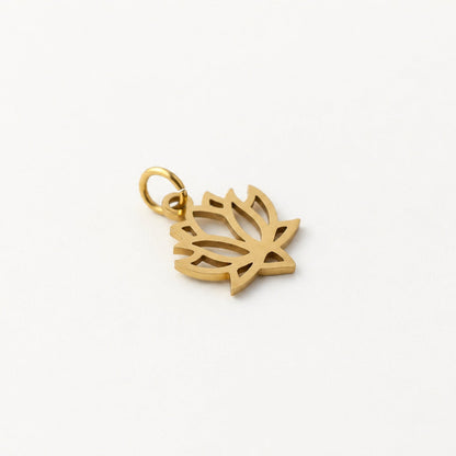 Angled gold-plated stainless steel openwork lotus pendant with attached jump ring on neutral ivory background