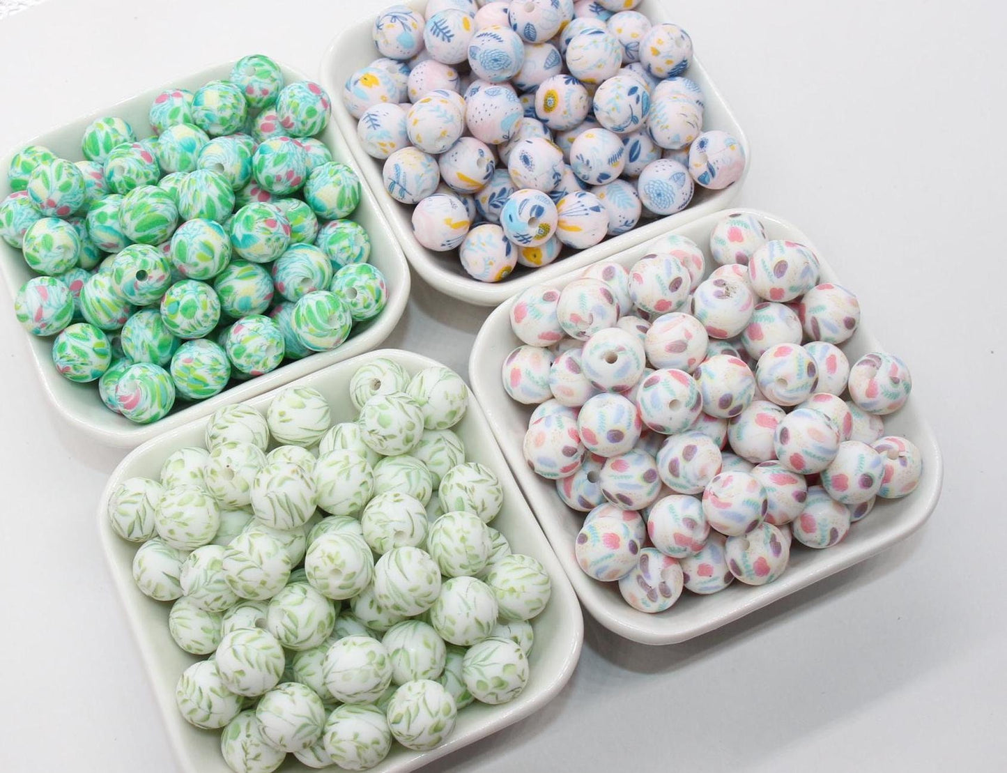 Four trays of colorful patterned candies on a white background.