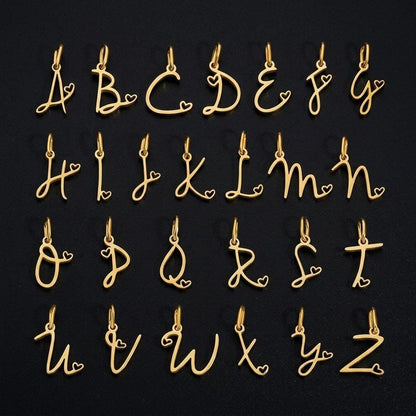 Gold script initial charms with heart accents, stainless steel alphabet letter pendants for necklaces and DIY jewelry making.