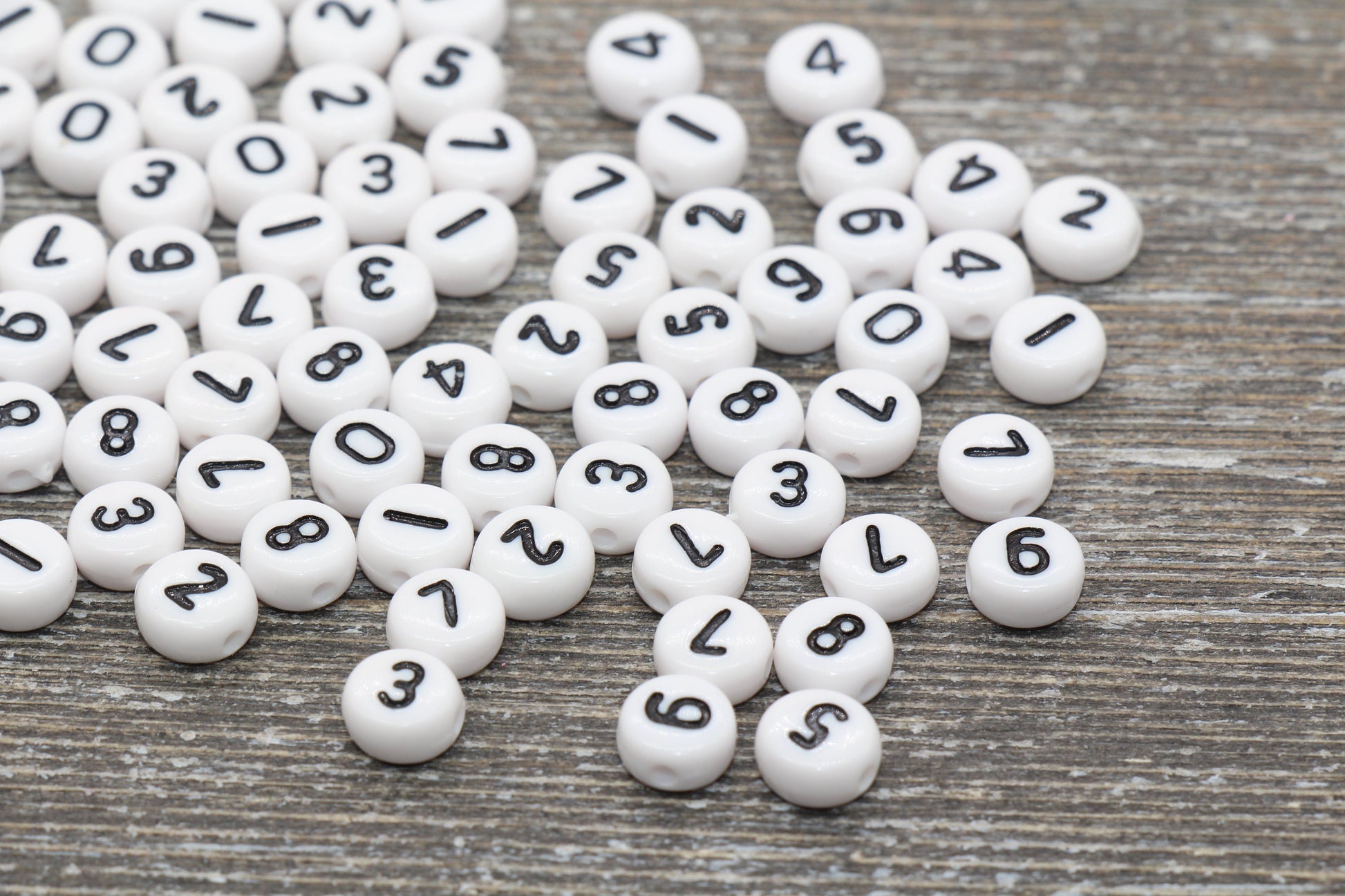 individual 7 mm flat round acrylic number beads, white with black numbers; white number beads