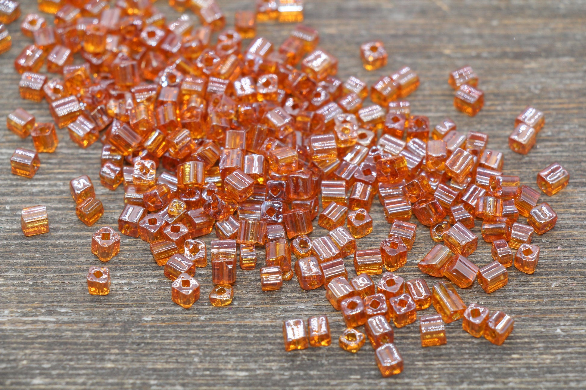 Transparent Orange Square Seed Beads, ideal for crafting jewelry such as bracelets and necklaces and other crafts.