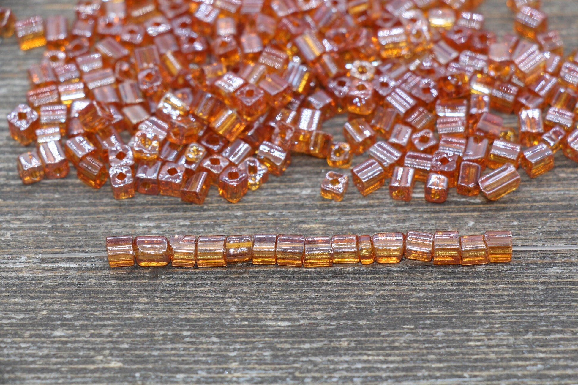 Transparent Orange Square Seed Beads, ideal for crafting jewelry such as bracelets and necklaces and other crafts.