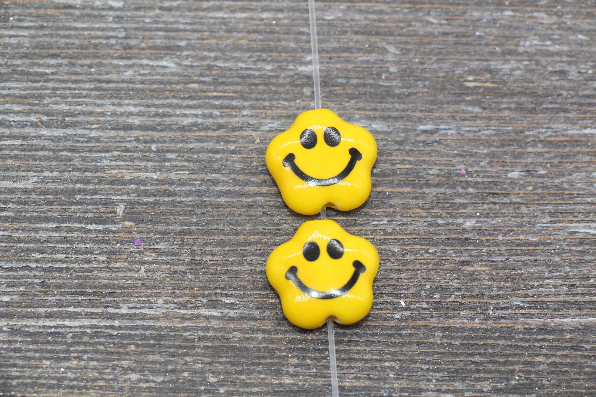 yellow facial expression beads, ceramic emoji beads, flat lay