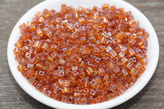 Transparent Orange Square Seed Beads, ideal for crafting jewelry such as bracelets and necklaces and other crafts.