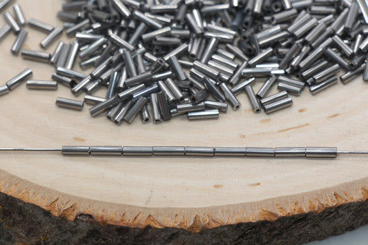 6mm Gunmetal Bugle Beads, perfect for embellishing clothing, accessories, and craft projects.